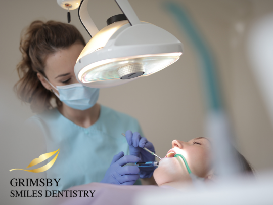 Emergency dental care at Grimsby Smiles Dentistry, featuring a dentist assisting a patient with a broken tooth